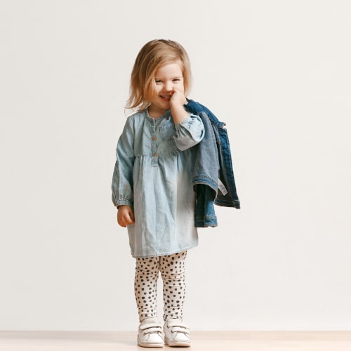 full-length-portrait-cute-little-kid-girl-stylish-jeans-clothes-smiling-standing-white-kids-fashion-concept-min