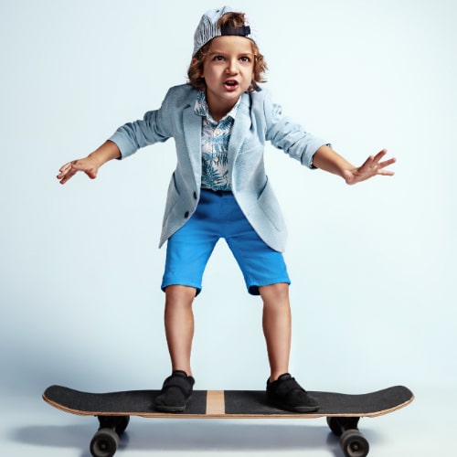 pretty-young-boy-skateboard-casual-clothes-white-wall-riding-looks-happy-caucasian-male-preschooler-with-bright-facial-emotions-childhood-expression-having-fun-min