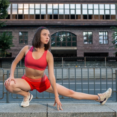 sporty-woman-stretching-warming-up-legs-before-running-urban-fitness-workout-sport-healthy-lifestyle-concept-female-athlete-exercising-outside-min
